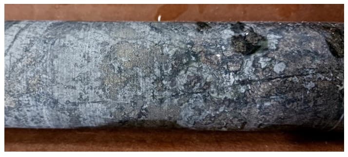 NQ drill core from hole TK21 at 3,944 ft depth showing brecciated skarn with visible chalcopyrite